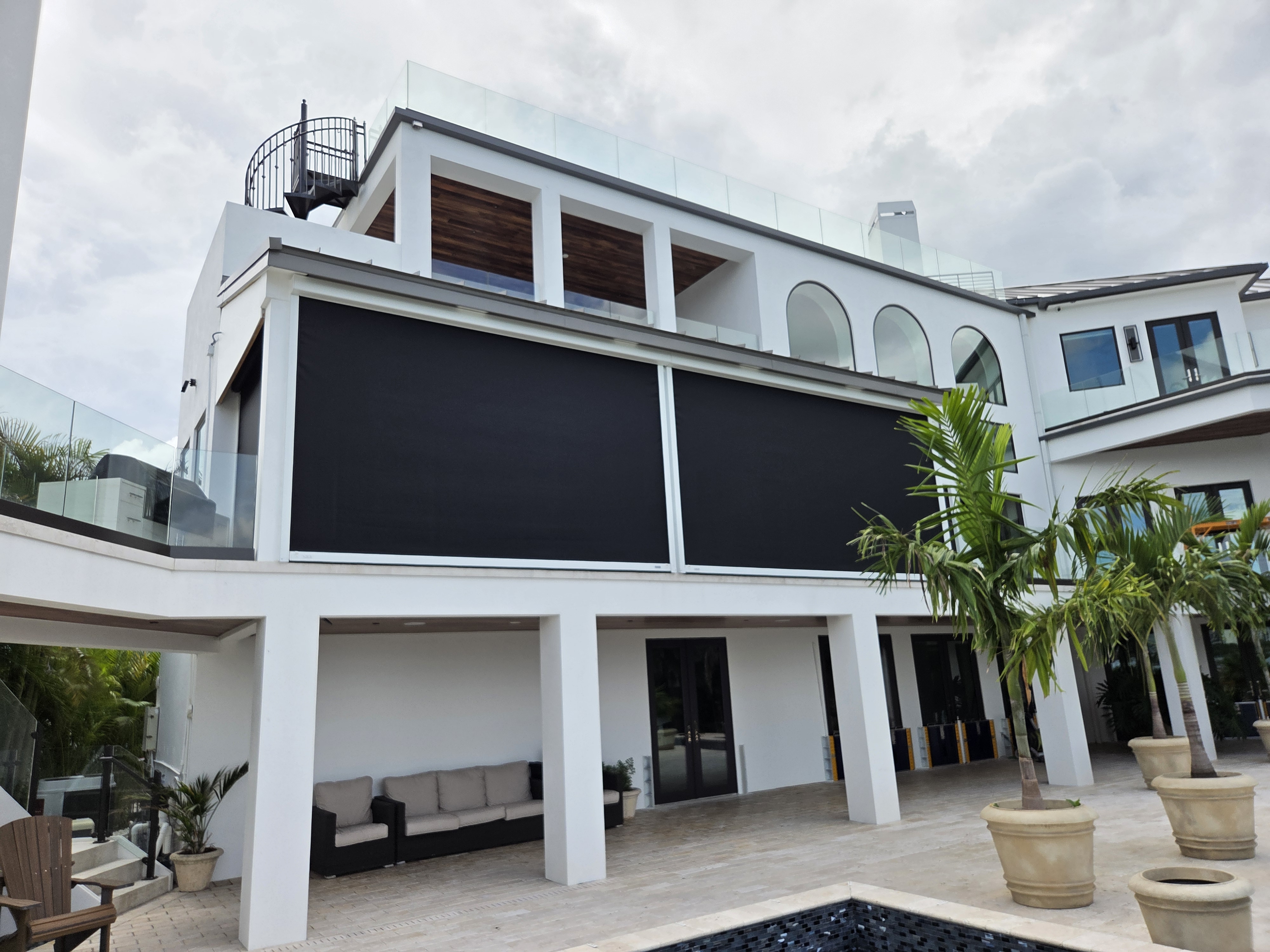 Motorized retractable screens on a luxury Sarasota estate balcony