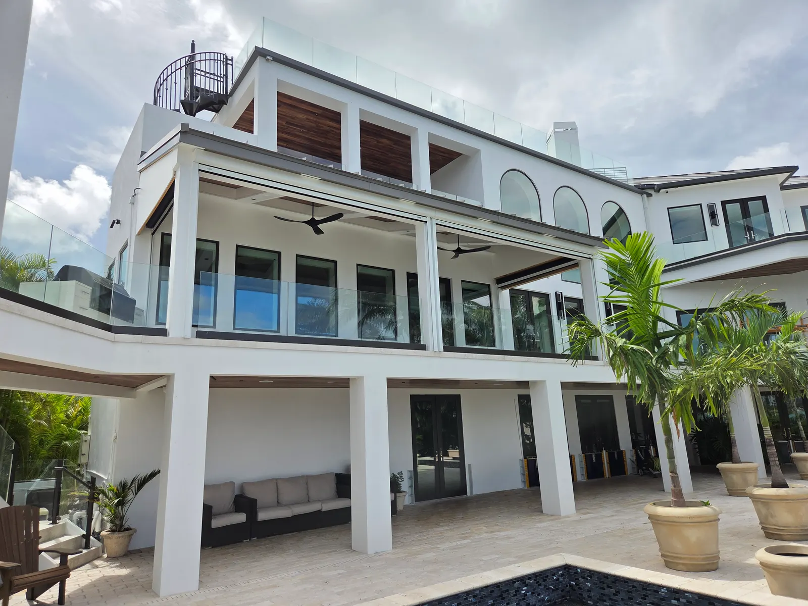 Motorized retractable screens deployed on a 3-story Sarasota waterfront home